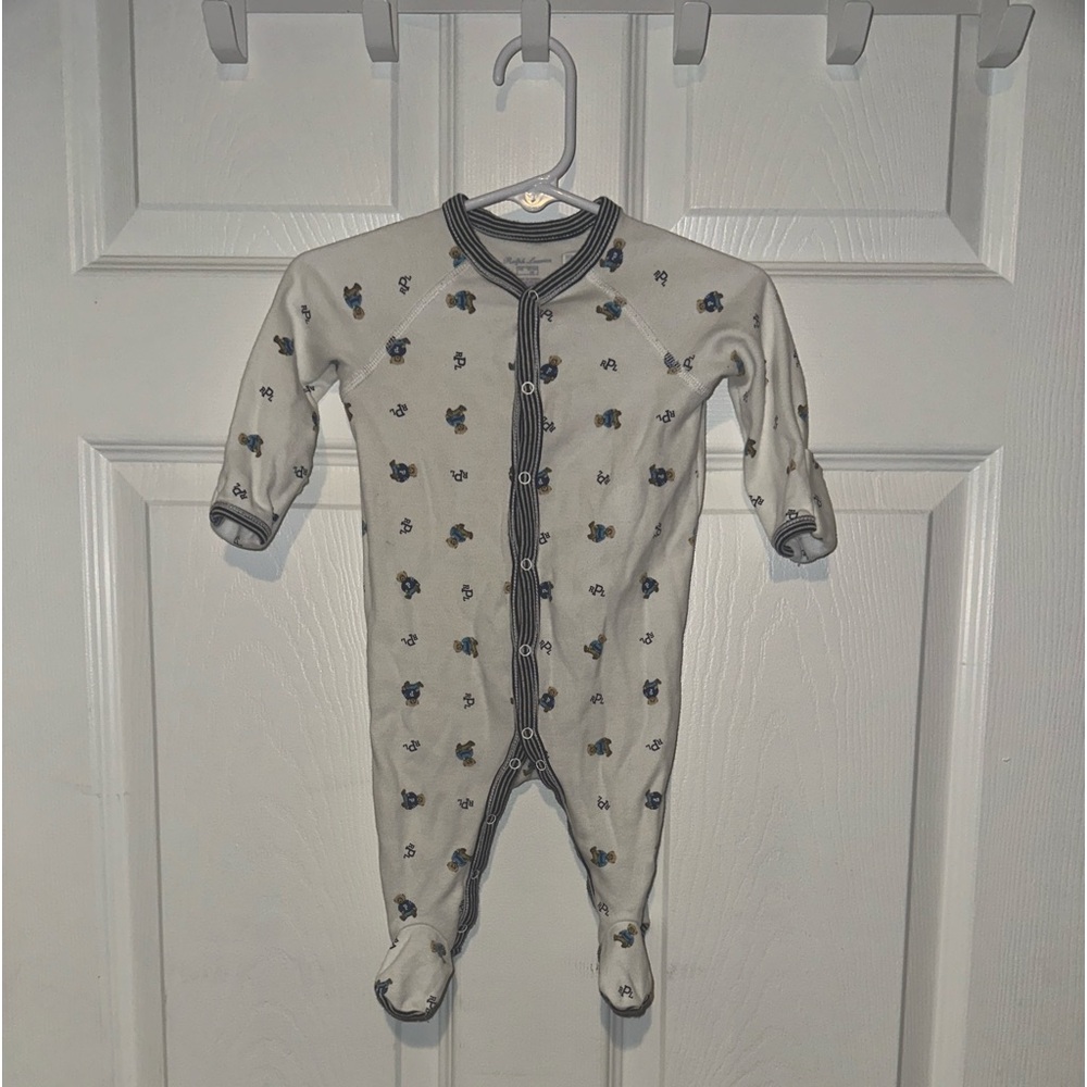This is a blue and white polo onesie in a size 3 months 🤍🥶!